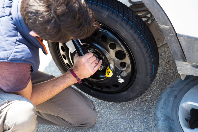 Tyre being fitted to a vehicle